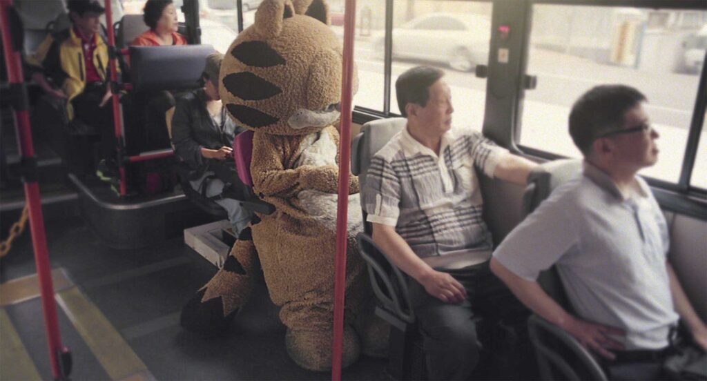 Cat finds solace by the window on a Seoul bus in Nana-D's 'Lose Against You' music video scene