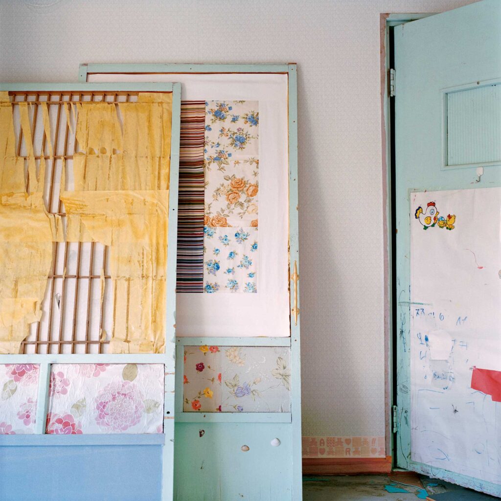 Colorful traditional Korean Hanji paper adorns two sliding door frames in an abandoned home in Seoul, South Korea