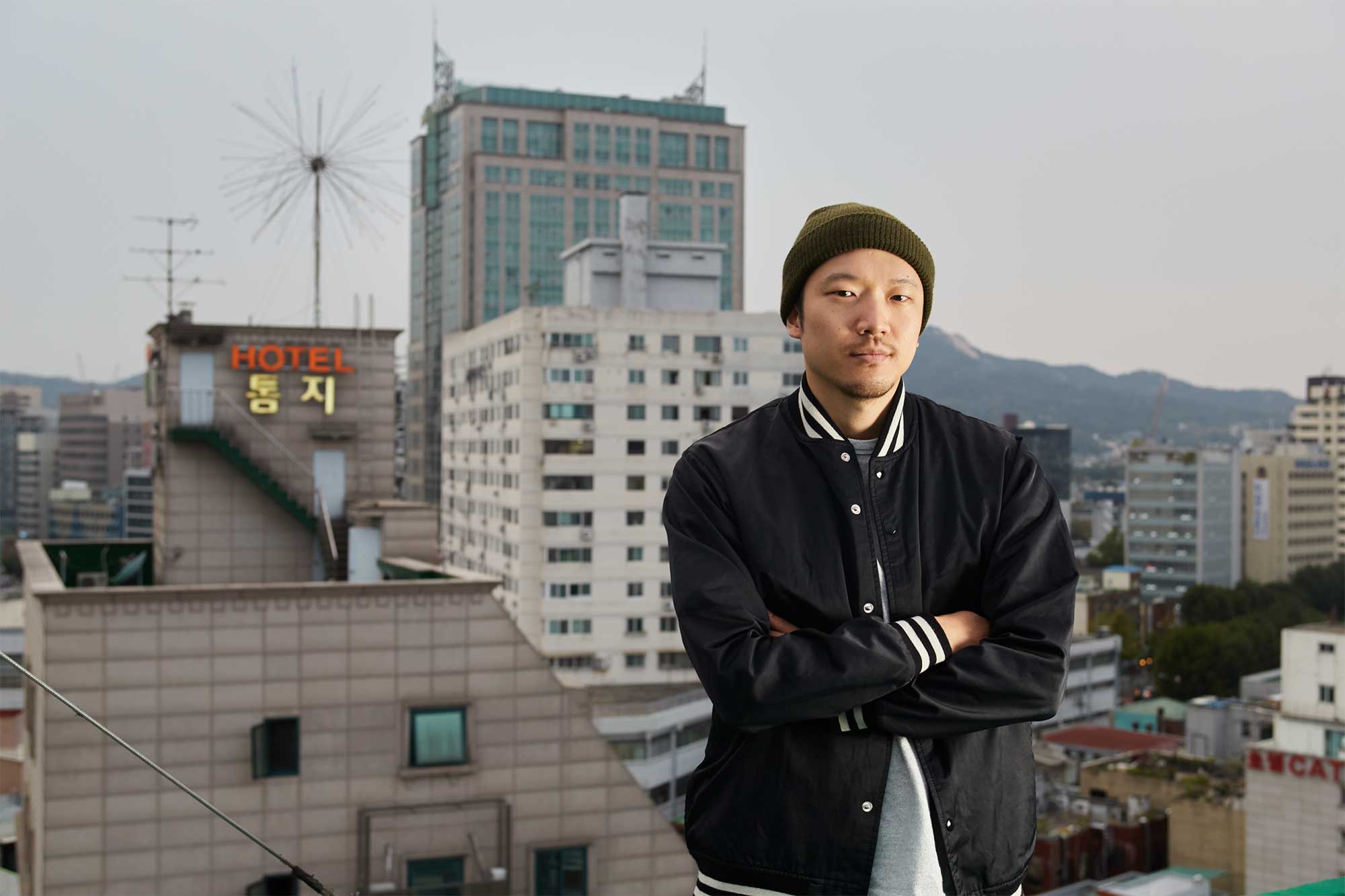DJ Soulscape (Min Jun Park) stands on a rooftop, overlooking Seoul, South Korea