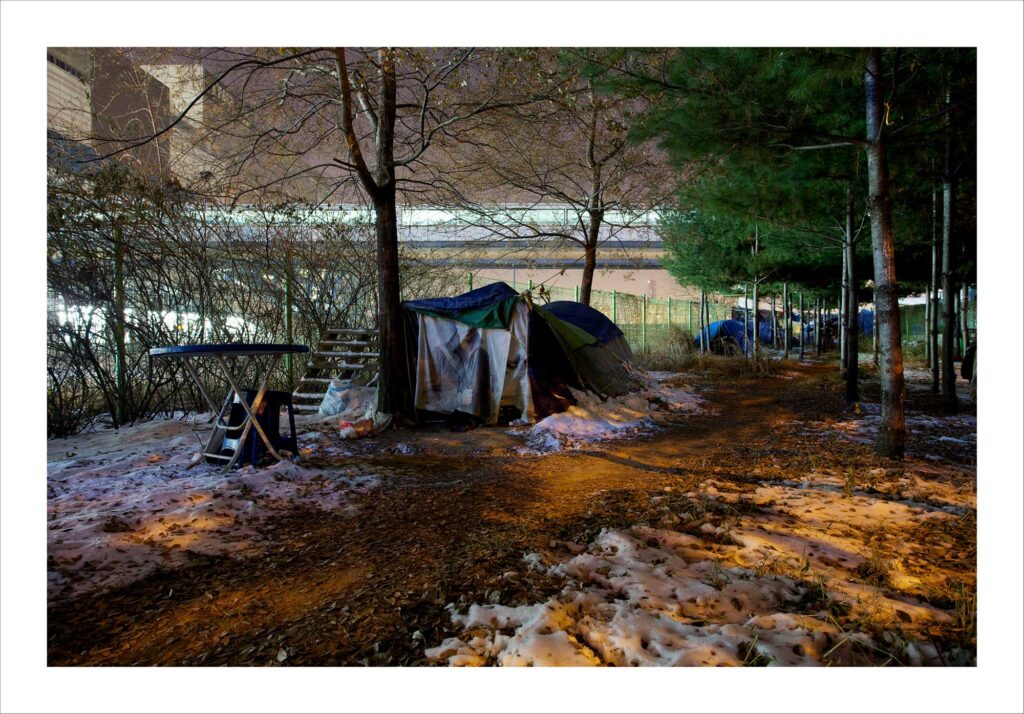Make-shift tents in a Seoul park near Yongsan station, symbolizing the resilience of a local homeless community