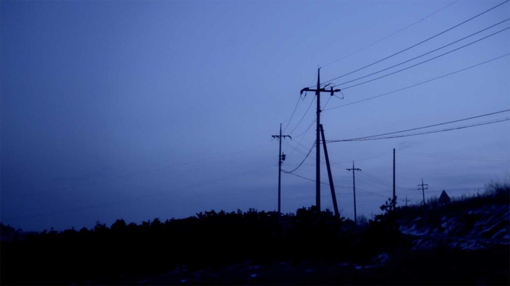 A scene from the Wolf + Lamb vs. Soul Clap 'Lonely C' music video: A very early morning scene captures the serene landscape around a countryside village in South Korea