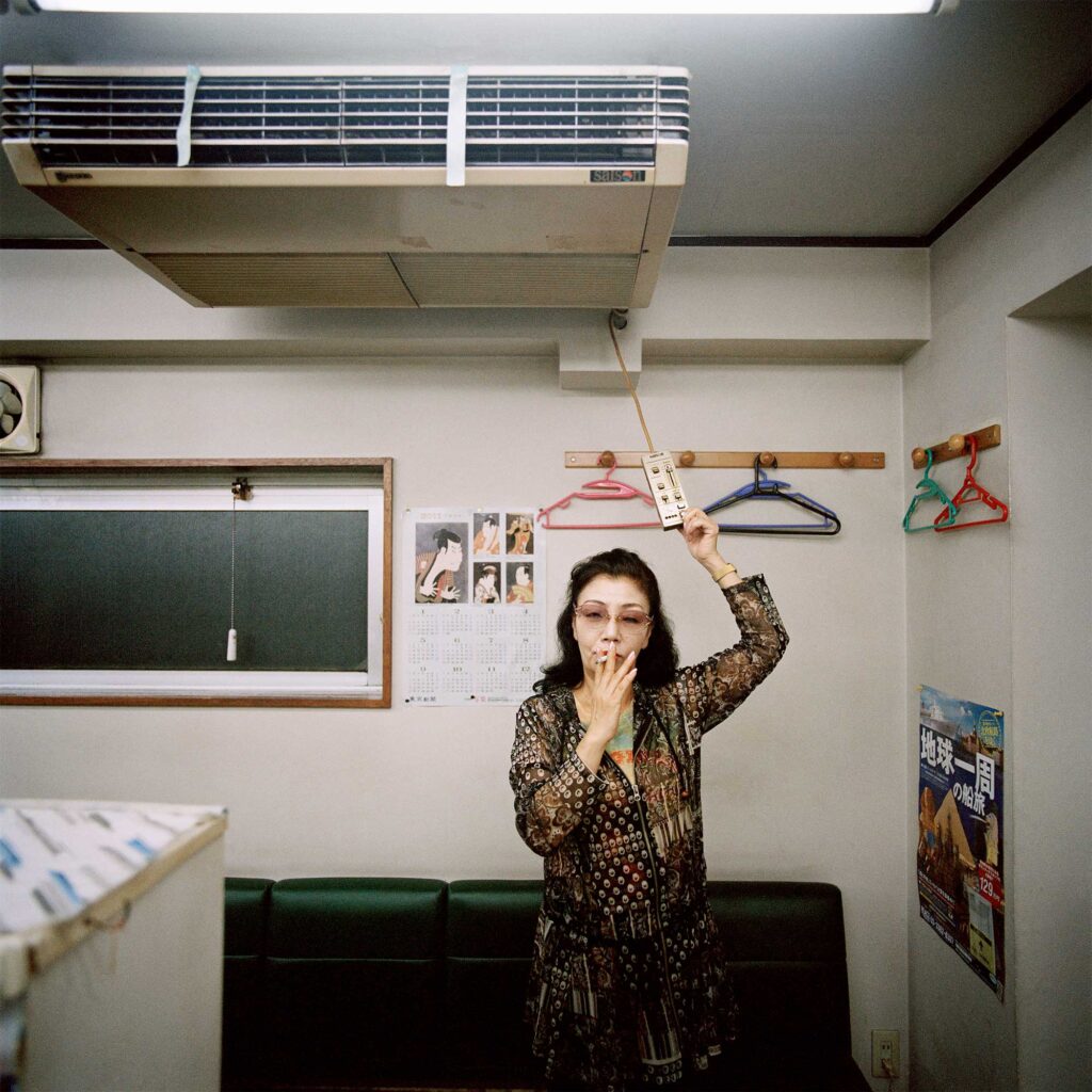 Elderly woman smoking in Tokyo hair salon, turns off air-con on hot summer day in Japan