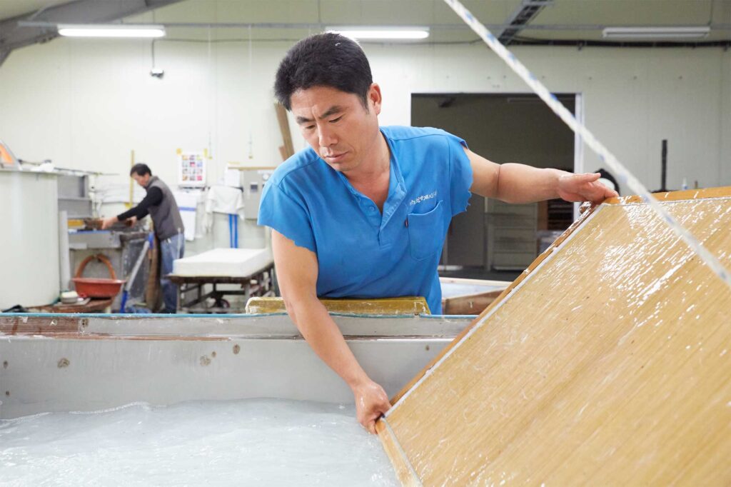 Korean man married to a Vietnamese woman in Bongdong, South Korea, at work at a Hanji paper manufacturing company