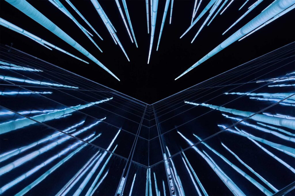 Night view: LED-lit blades reflect on GS Caltex building's mirrored facade in South Korea