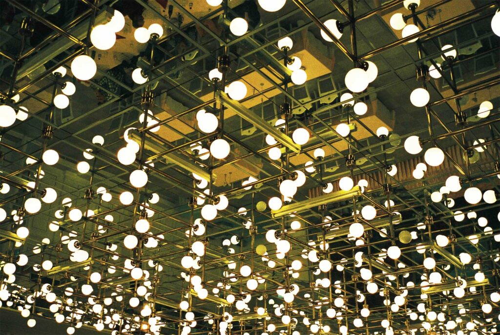 A plethora of round light bulbs adorning the ceiling of a dining hall in Pyongyang, North Korea.