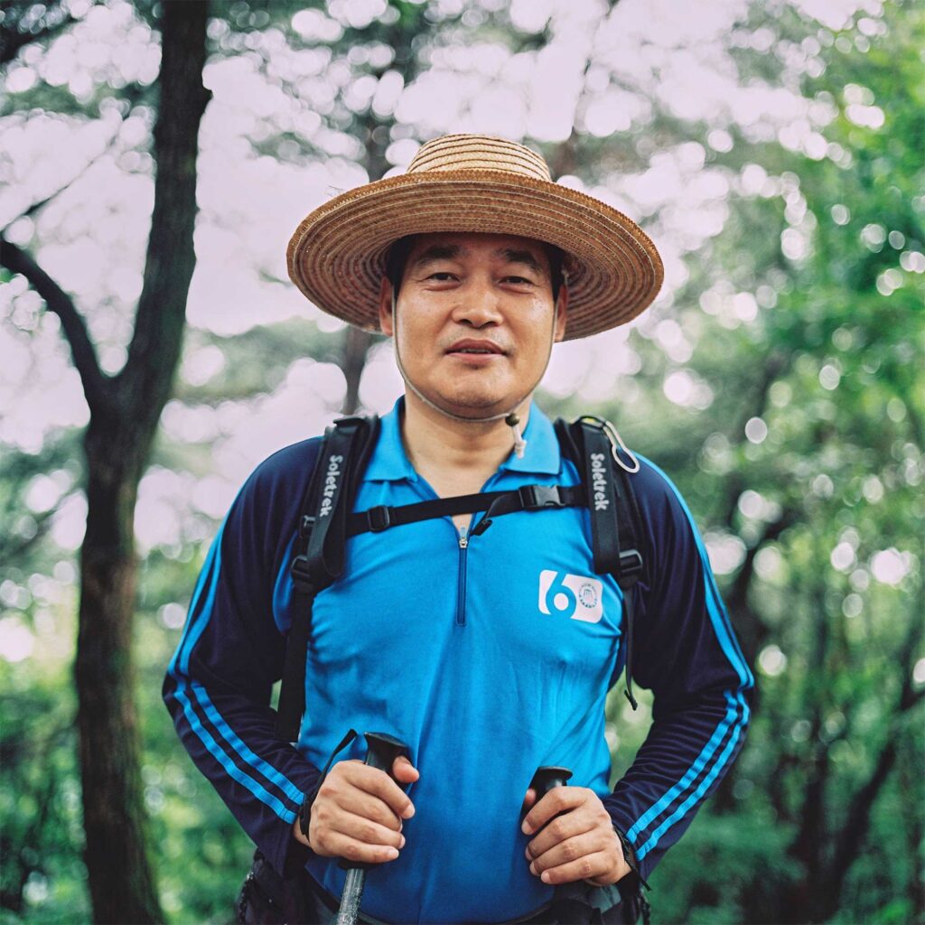 A Korean man hikes one of the surrounding mountains of Seoul, South Korea, on a hot summer afternoon