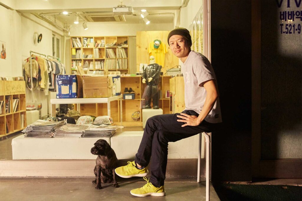 DJ Soulscape (Min Jun Park) sits with his dog outside 360 Sounds record label store in Seoul, South Korea