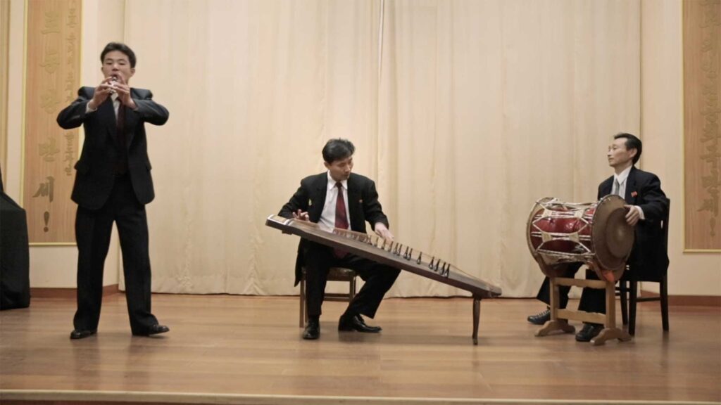Three North Korean musicians performing traditional Korean instruments at Kim Won Gyun Conservatory, Pyongyang, North Korea