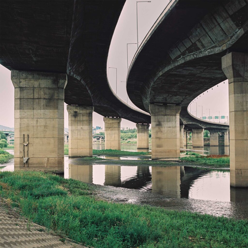 Two lanes of a highway along the edge of the Han River in Seoul, South Korea, viewed from underneath