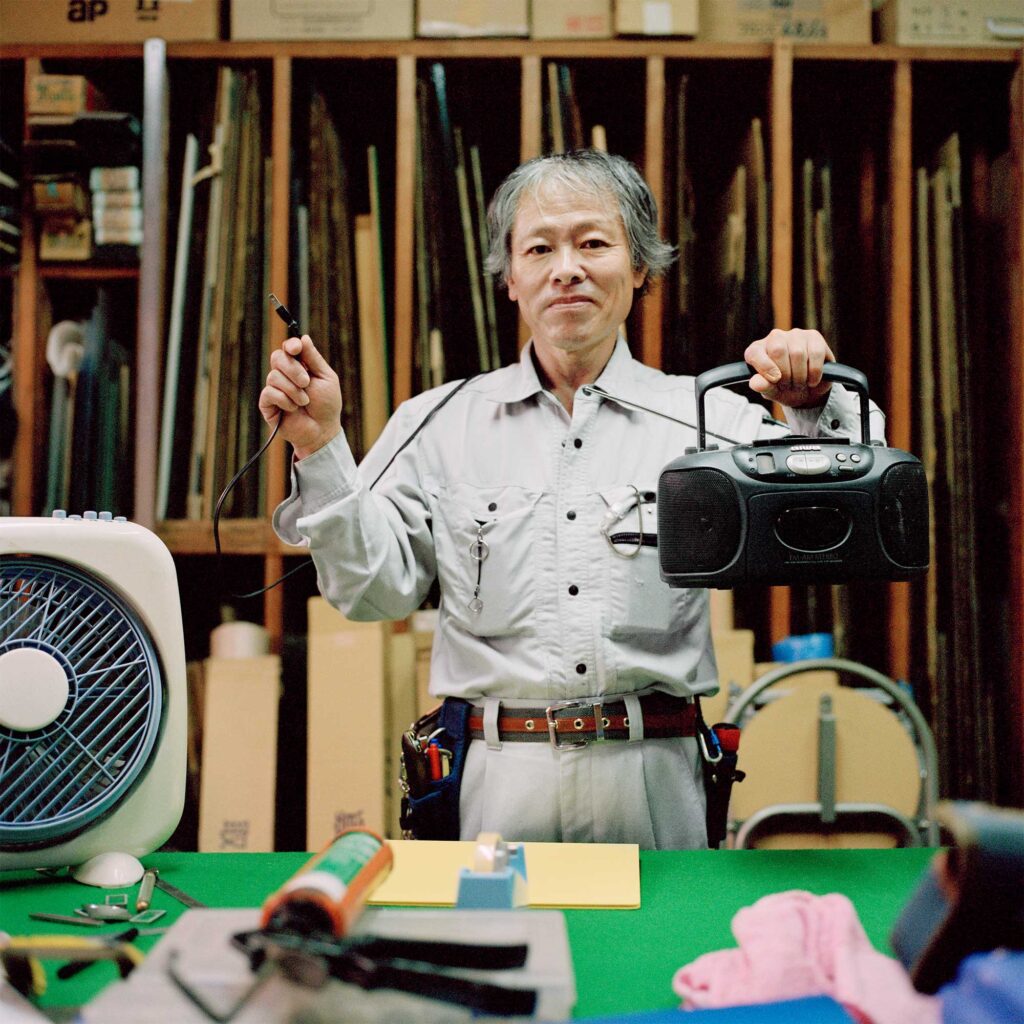 Carpenter in Tokyo workshop unplugs radio, conserving energy post-Fukushima