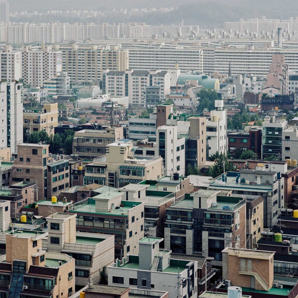 Korean style villa buildings with Seoul apartment landscape in background