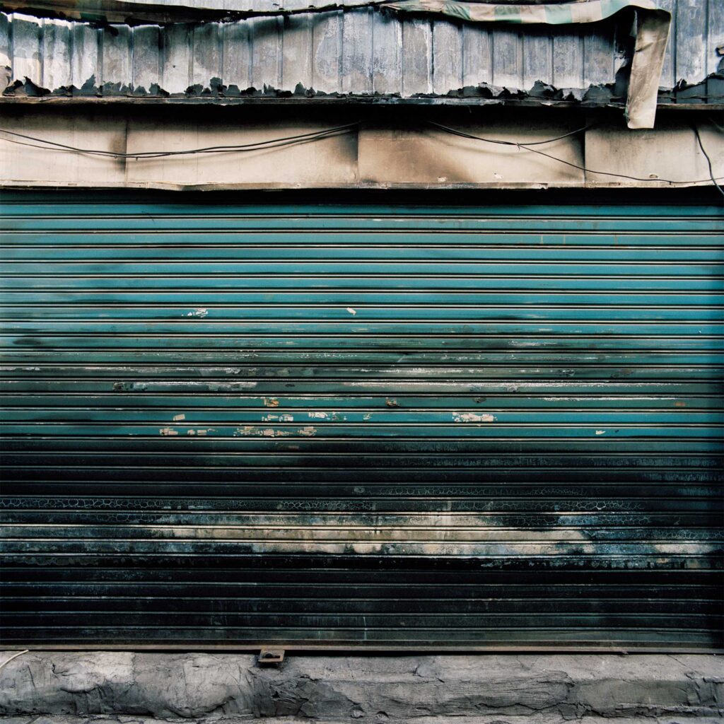 The metal gate of a handcraft vendor in Jongro, Seoul, South Korea, bears a unique texture from mold and fire stains