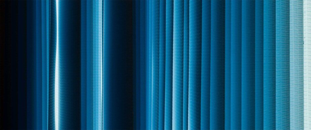 Office curtain panels illuminated by backlight, displaying varying blue gradients