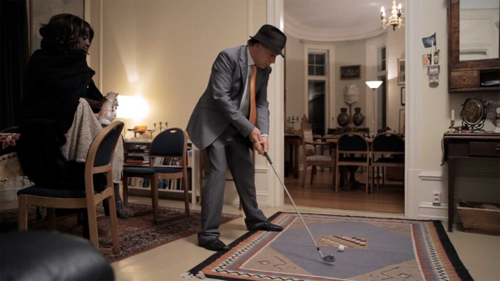 "Look Right Through" Storm Queen Music Video - Male talent poised to swing golf club in invaded Oslo home.