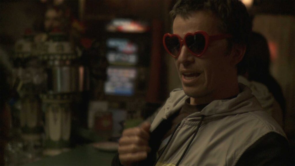 Crisjan Zollner in a bar in Berlin wearing heart shaped glasses