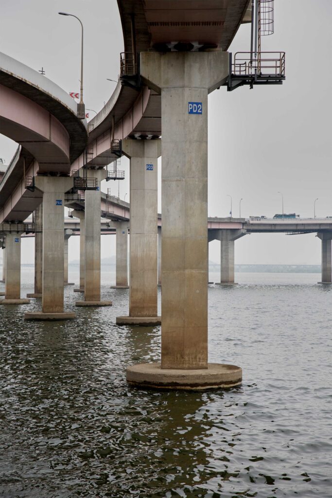 The foundation poles of a highway flyover extend into the waters of the Han River in Seoul, South Korea