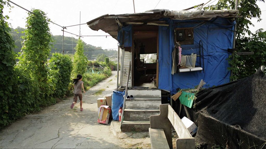 A young girl in the short film "Cold Summer" running away from her scabby home in a run-down neighborhood in Seoul, South Korea