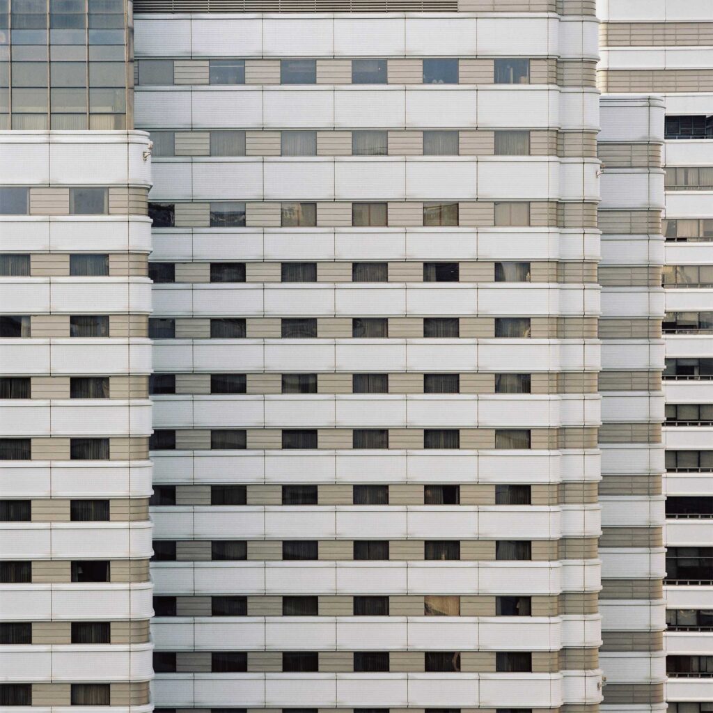 Monumental concrete facade in Seoul's Gangnam district, featuring rounded edges that add depth to the structure