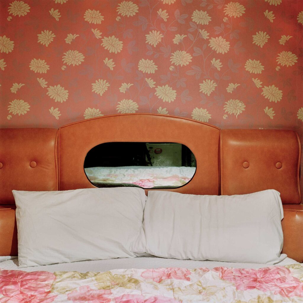 A floral-printed wallpaper adorns the bed in a vintage motel room in Seoul's Jongro district, evoking a retro charm