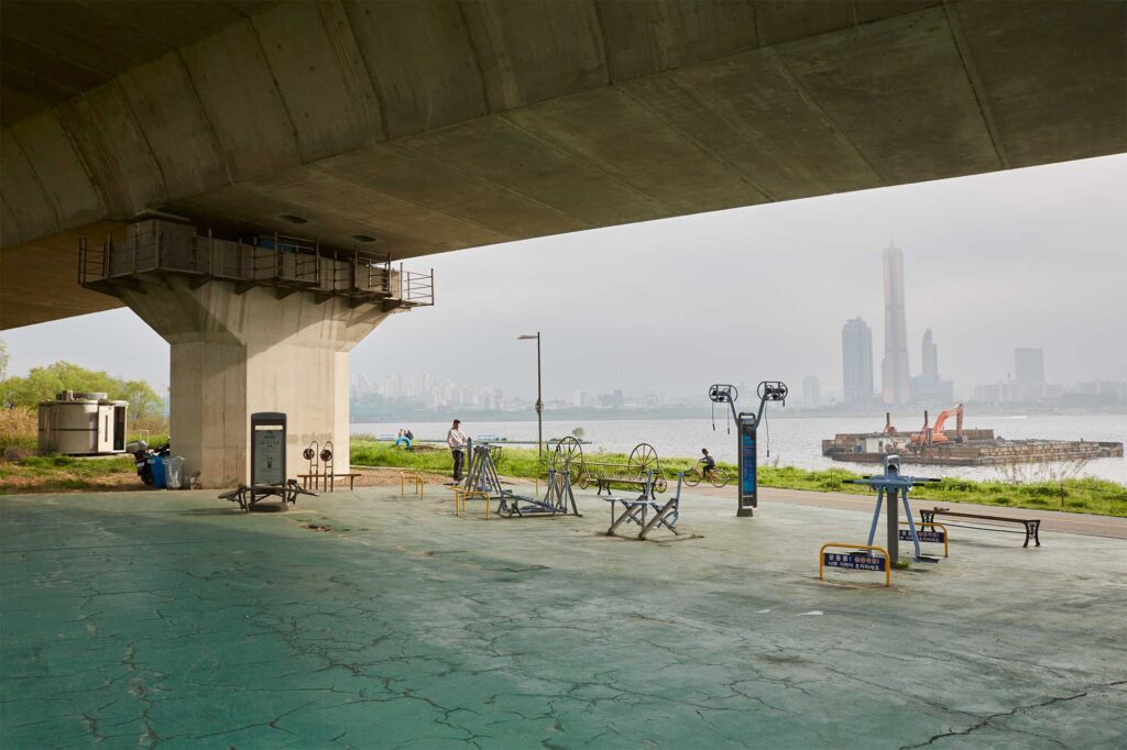 A lone visitor on an exercise sports ground next to Han River in Seoul, on the opposite side of Yeouido
