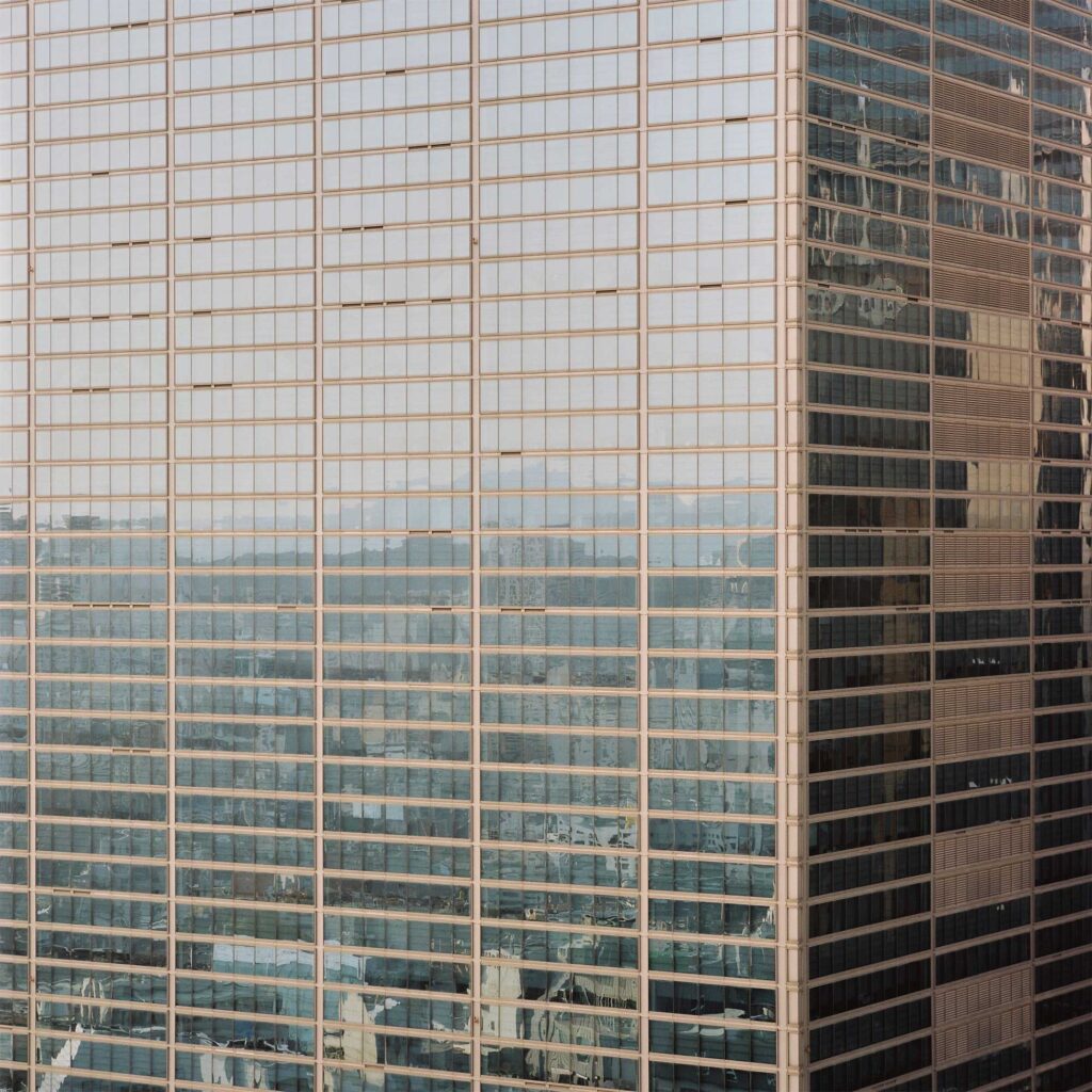 Massive glass office building with a linear pattern in Gangnam, Seoul. Reflecting its vibrant surroundings, it enhances the urban landscape
