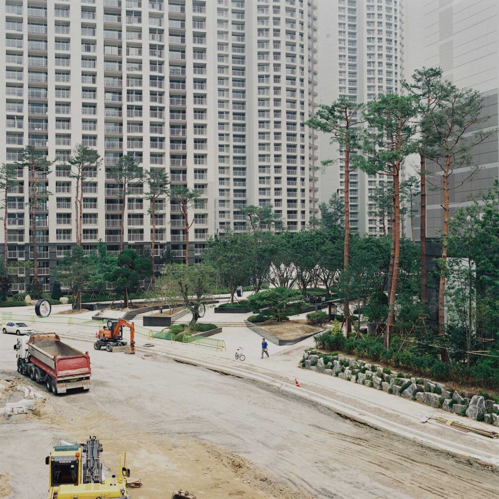 Final touches being applied to a newly constructed apartment complex in Seoul, South Korea, including the building of the road that runs through the complex itself
