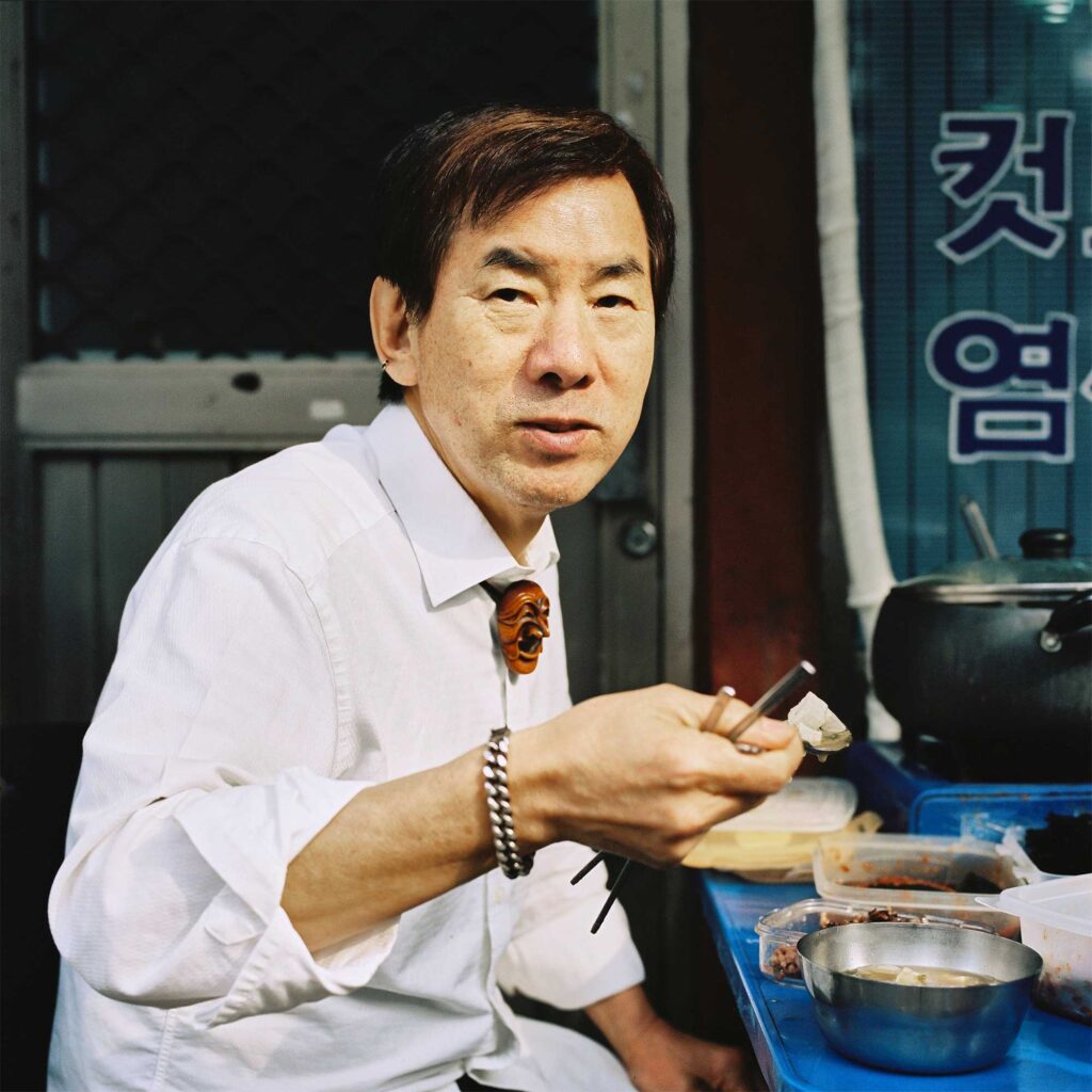 A Korean man enjoying his Korean lunch outside a restaurant in Seoul, South Korea