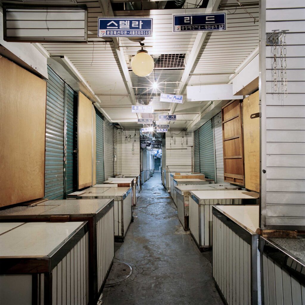 At Dongdaemun market near Jongro in Seoul, South Korea, vendors shutter their shops, leaving the alley deserted
