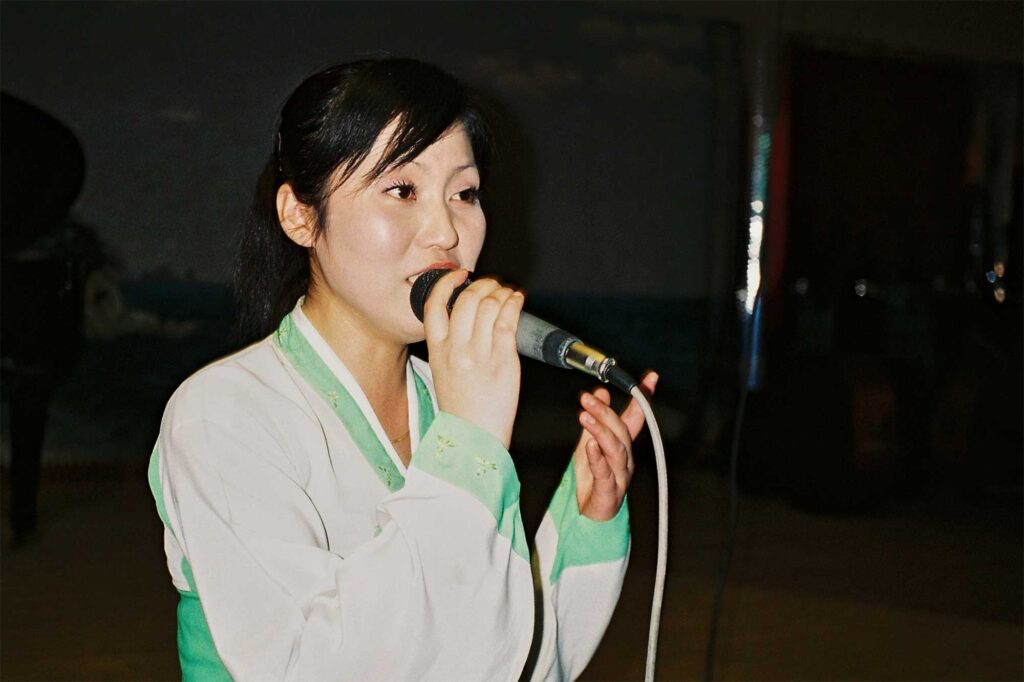 A female singer performer dressed in a traditional Korean dress performs at a restaurant in Pyongyang, North Korea