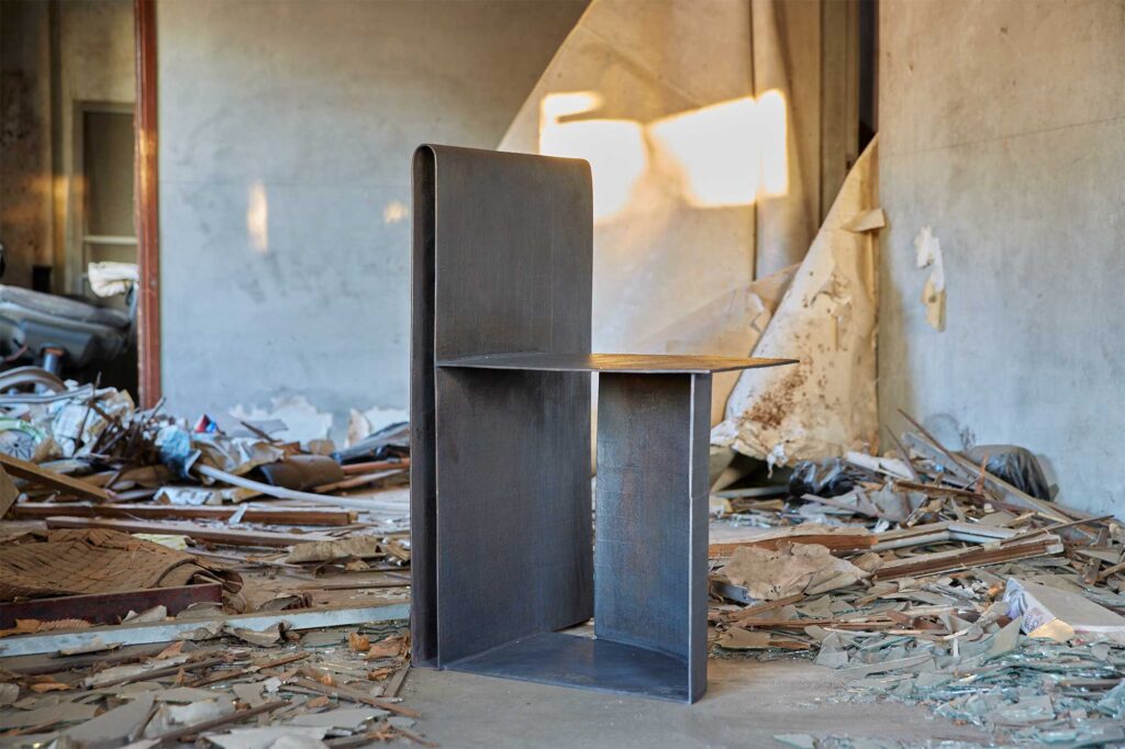 A lacquer-coated bronze furniture piece by Korean artist Kwangho Lee, winner of the 2013 YÉOL Young Craftsman Award, in an abandoned home with a demolished interior.