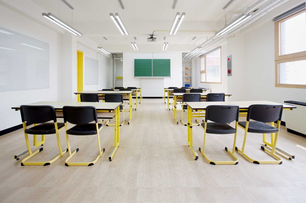Architectural details of Deutsche Schule Seoul International (DSSI) featuring vibrant, color-coded doors, including a bright yellow tone for one of the school classrooms, designed by Zabel & Partners Architects.