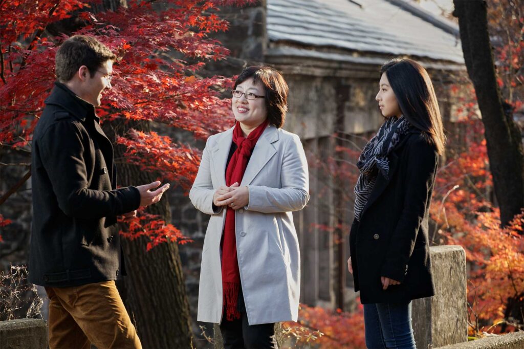 The dean of Underwood International College, Yonsei University, speaks to students outside on a colorful autumn day in front of a historic building on Sinchon Campus, South Korea.