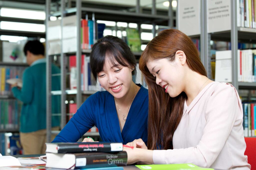 Two Korean students study together in the library to improve their German language skills at the Goethe Institut in Seoul.