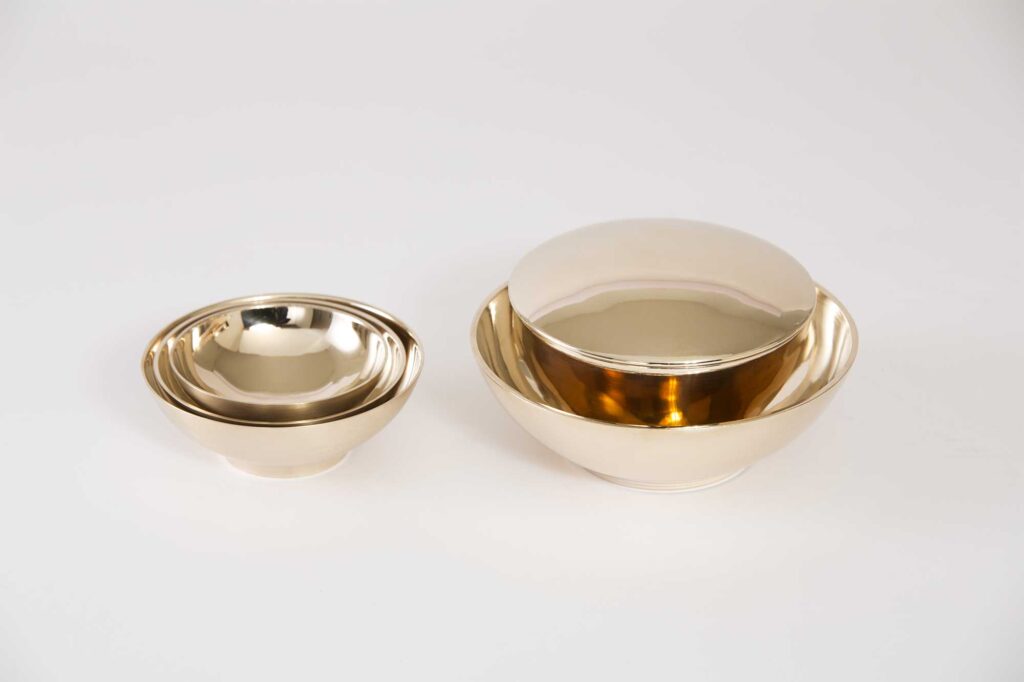 Different sized bowls from the Korean traditional brass kitchenware collection designed by Gio Kisang and crafted by YÉOL Artisan of the Year, Kim Soo-Young, nested together.