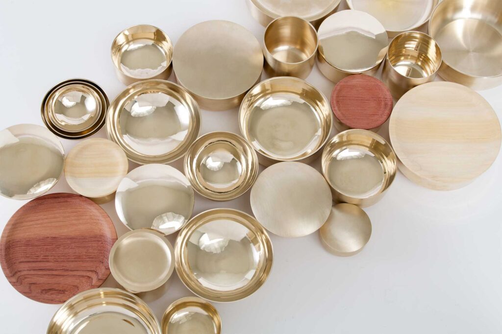 Top view of a wide selection of Korean traditional brass kitchenware designed by Gio Kisang and crafted by YÉOL Artisan of the Year, Kim Soo-Young.