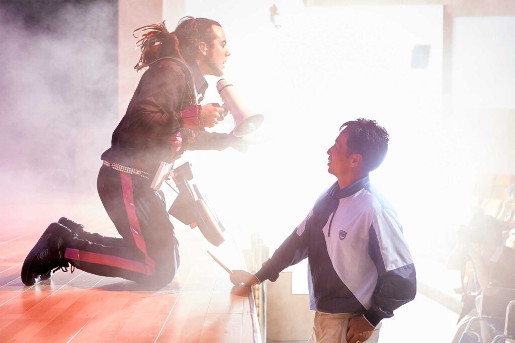 Sweden’s National Day event at the World Exhibition in Yeosu, South Korea, featuring an engaging music performance with the Swedish lead singer interacting with a Korean visitor at the edge of the stage.