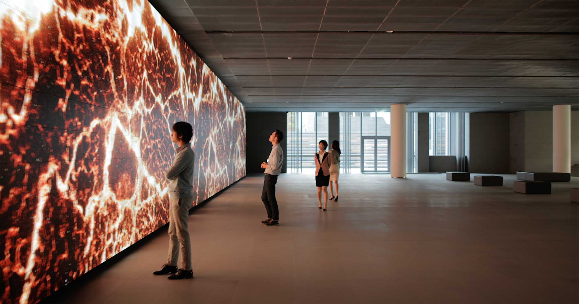 Visitors gather around the Vision Hall Media Wall, showcasing Universal Everything's dynamic art installation at Hyundai Motor Group University, Mabuk Campus, South Korea.
