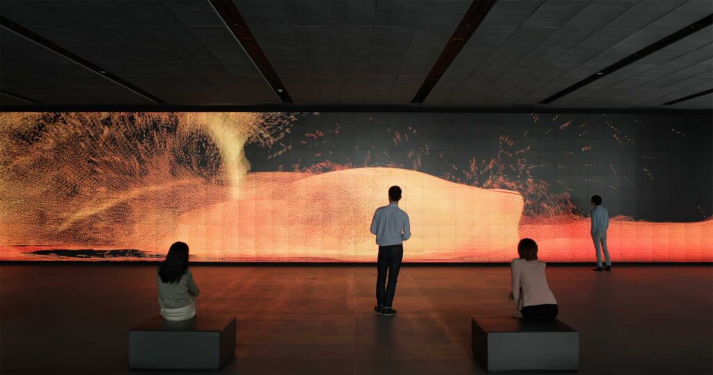 Visitors gather around the Vision Hall Media Wall, showcasing Universal Everything's dynamic moving fire art installation at Hyundai Motor Group University, Mabuk Campus, South Korea.