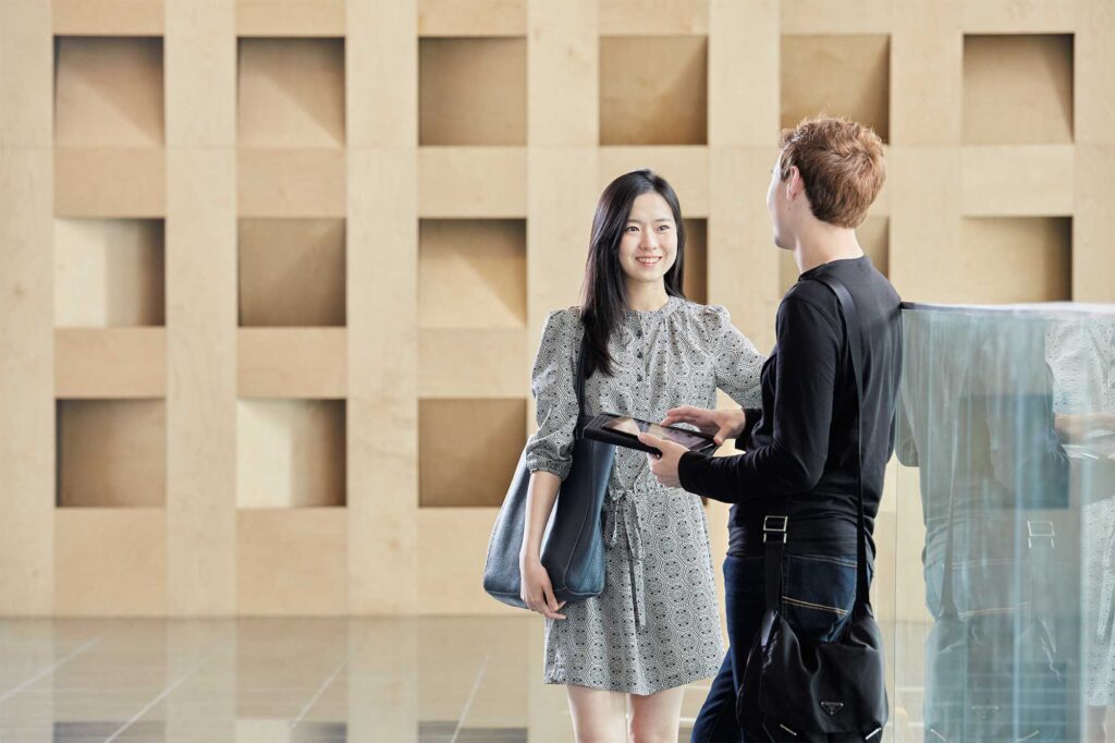 Two Underwood International College students focus on their class preparation in a spacious hall at the Songdo campus of Yonsei University, Seoul, South Korea.