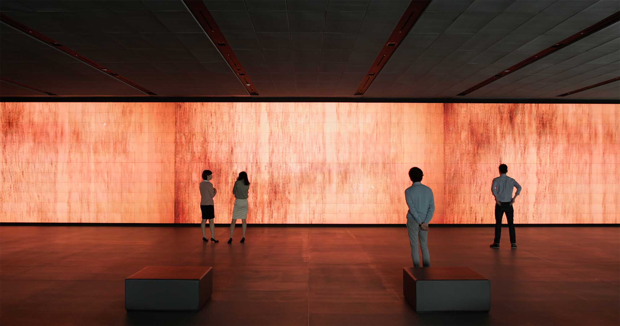 Visitors gather around the Vision Hall Media Wall, showcasing Universal Everything's dynamic moving fire art installation at Hyundai Motor Group University, Mabuk Campus, South Korea.