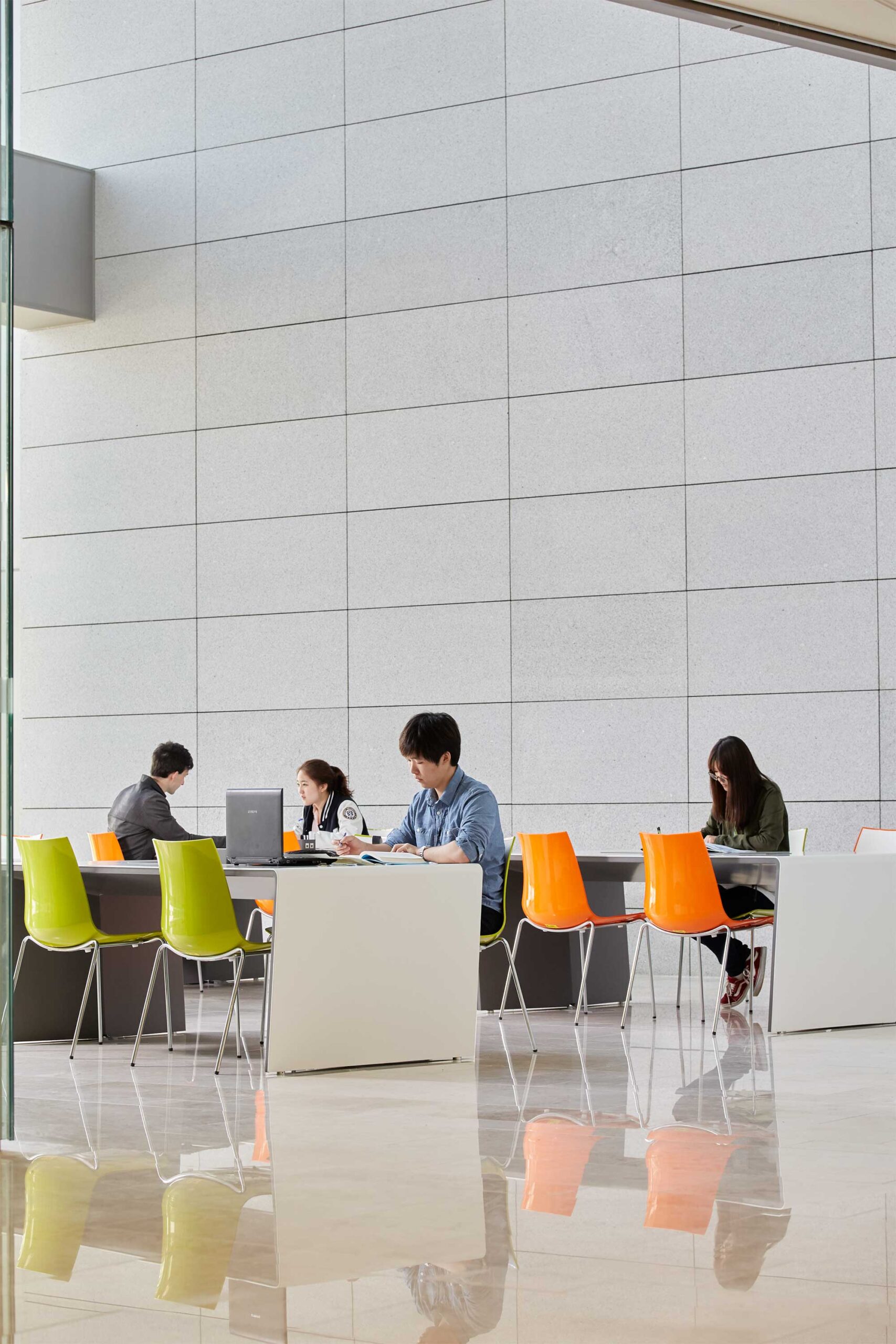 A couple of Underwood International College students collaborate in a spacious, modern workspace at Songdo campus, Yonsei University, Seoul, South Korea.