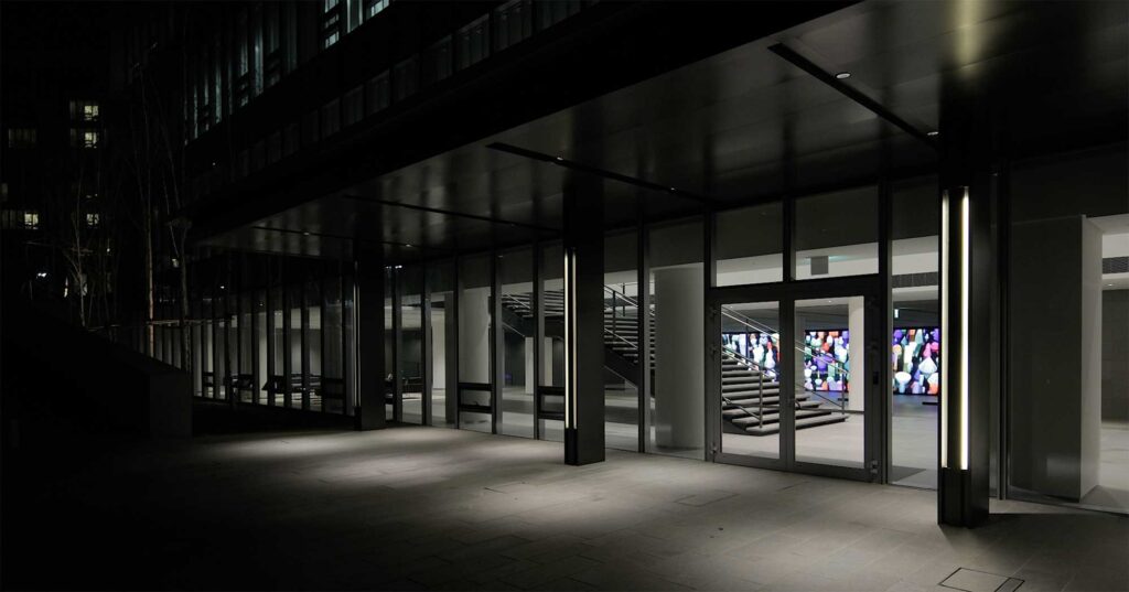 Hyundai Motor Group University, Mabuk Campus, South Korea, from outside at night with the Vision Hall Media Wall, showcasing Universal Everything's dynamic art installations