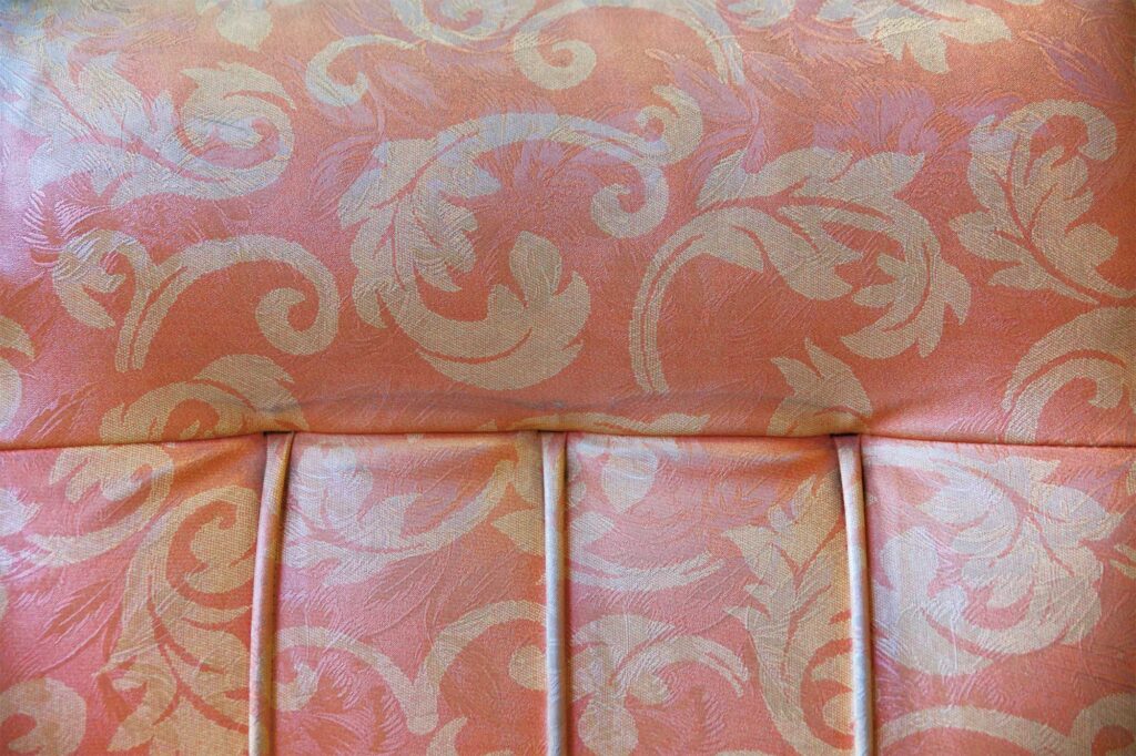 Close-up of a worn, patterned sofa in a traditional Korean coffee shop in Seoul, featured in AS IT IS magazine’s issue on the beauty of aging.