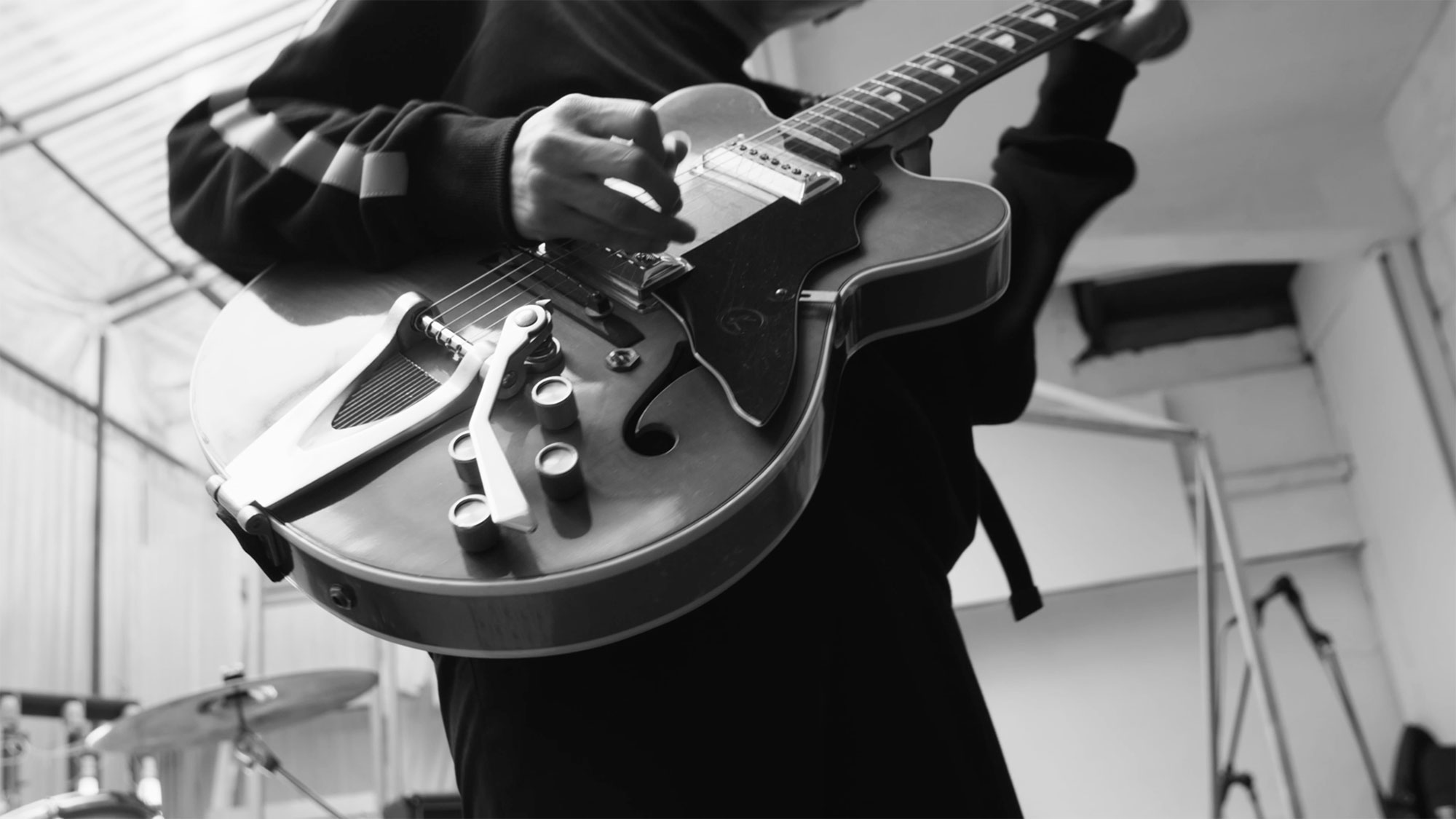 Close-up of guitar played by Korean musician in winter garden extension of building in Seoul, South Korea, for music video "Beautiful Woman" from Tune-Up Joong-Hyun Shin: Origin tribute album.