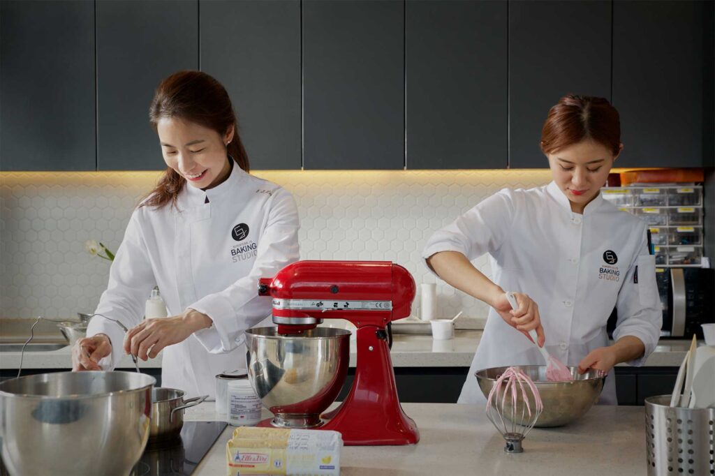 Pastry chef Eun Jeong Lee works alongside her staff in the baking studio at EJ Baking in Seoul, captured for the ELLE & VIRE PROFESSIONNEL PRINT MAGAZINE series.