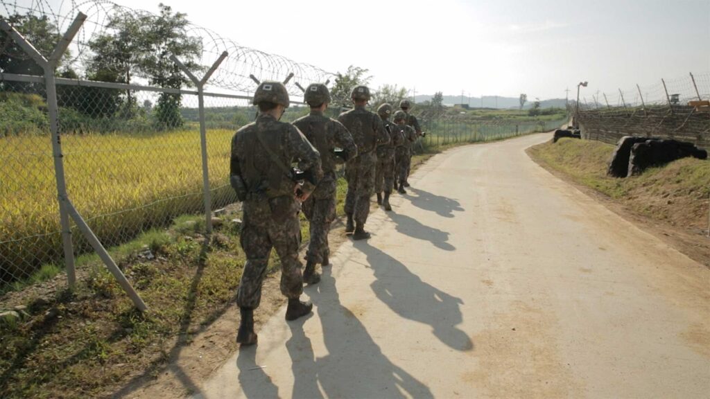 Soldiers marching in line next to DMZ dividing South Korea from North, close to Cherwon in Kangwando Province in short film ART ATTACK.