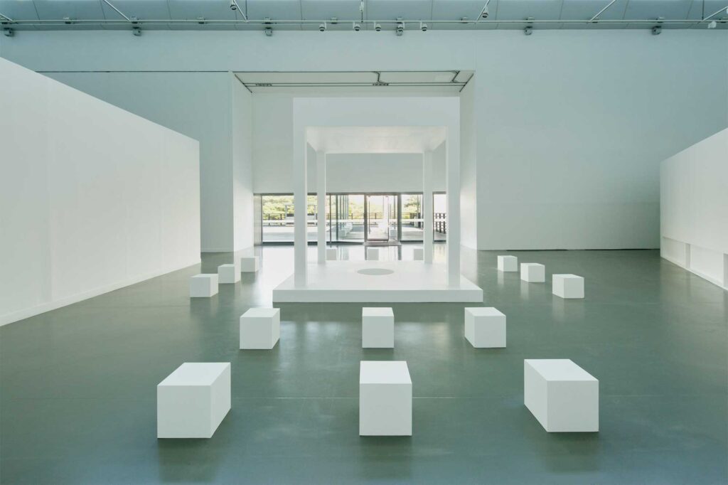 White architectural pavilion surrounded by square white chairs, set against an open exterior space at Irony & Idealism exhibition, Gyeonggi Museum of Modern Art, South Korea.