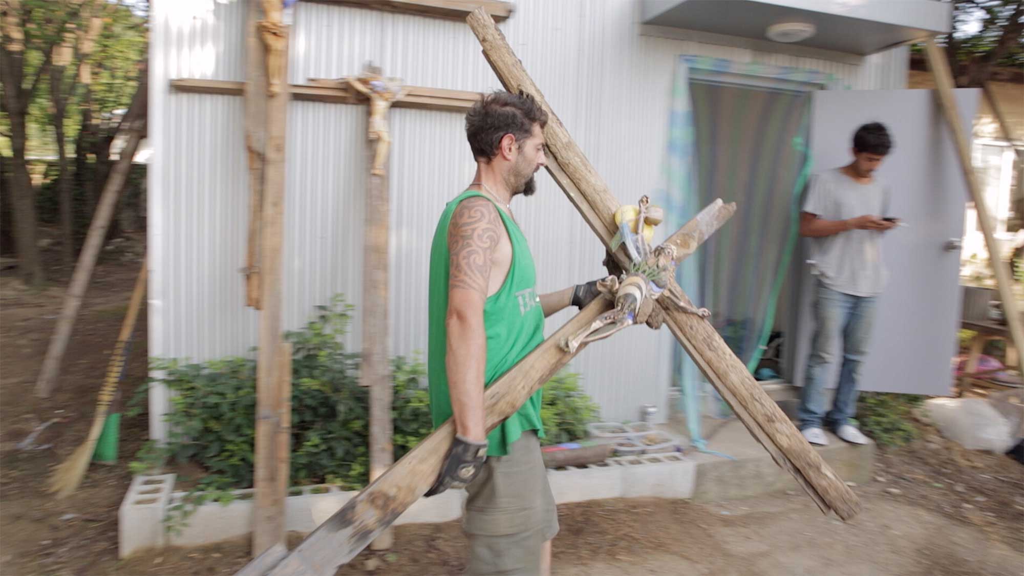 Artists in residency at small village Yangjiri near Cherwon, Kangwando Province, creating art by nailing Jesus figures to crosses in short film ART ATTACK.