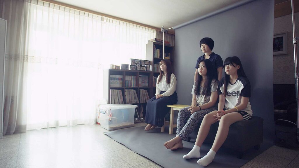 A mother and her three daughters pose for a portrait, leaving an empty chair for her fourth daughter, who was among the many lives lost in the Sewol ferry disaster in South Korea