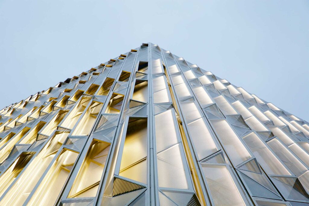 A semi-transparent wrapping of the golden facade at The Burberry Flagship Store creates an artistic pattern, enhancing its modern architectural design in Seoul, South Korea.